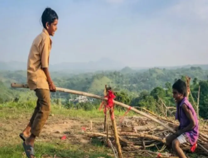 Two children are playing in a seesaw